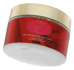 Nourishing salt scrub in vibrant red container.